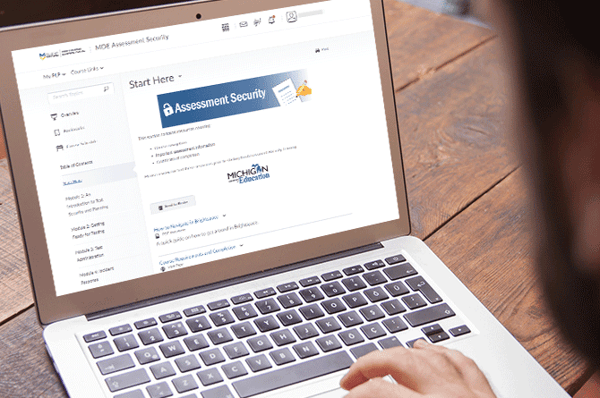 person working on MDE assessment security training course laptop